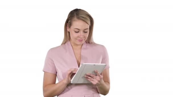 Cute, beautiful girl with tablet on white background. Professional shot in 4K resolution. 005. You can use it e.g. in your commercial video, business, presentation, broadcast  - Záběry, video