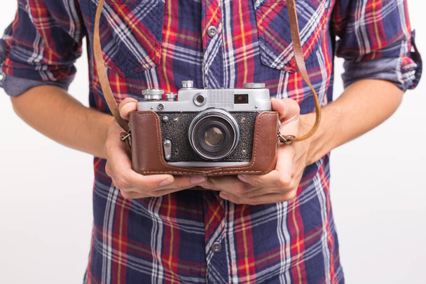 Vintage, photographer and hobby concept - close up of retro camera in mans hands over the white background - Foto, imagen