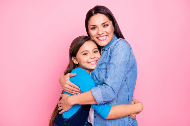 Portrait of two nice cute adorable lovable lovely attractive charming tender cheerful cheery positive girls hugging care trust feelings isolated over pink pastel background - Foto, imagen