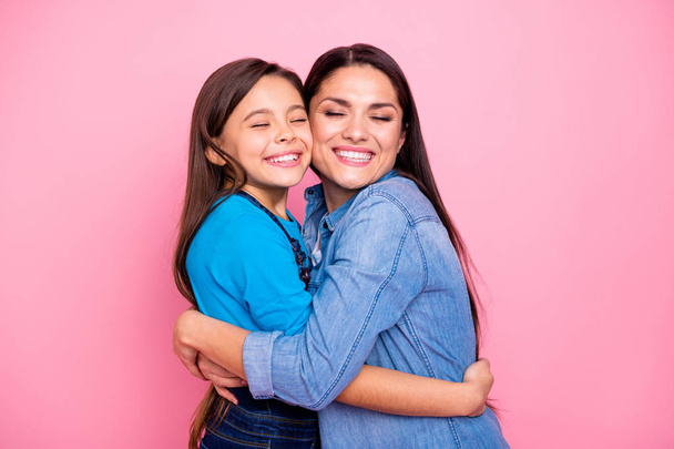 Portrait of two nice cute pretty trendy stylish lovely attractive charming tender cheerful positive girls hugging care trust feelings new family life closed eyes isolated over pink pastel background - Fotoğraf, Görsel