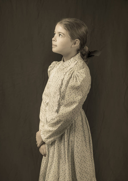 Little girl in turn of the 20th century clothing in replica antique photo. - Fotografie, Obrázek