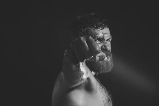 Fist with blood of bearded man on black background - Φωτογραφία, εικόνα