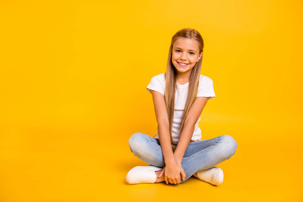 Portrait of her she nice cute sweet attractive cheerful straight-haired pre-teen girl sitting in lotus pose isolated over bright vivid shine yellow background - Photo, Image