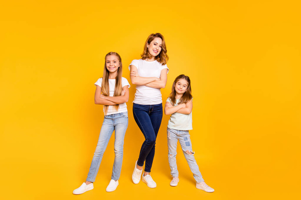 Full length body size view portrait of three nice attractive slim cheerful cheery people folded arms mum mommy isolated over bright vivid shine yellow background - Photo, image
