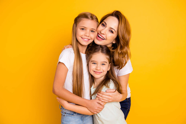 Portrait of three nice cute winsome lovely sweet tender attractive cheerful caucasian people cuddling mum mommy trust care isolated over bright vivid shine yellow background - Fotografie, Obrázek