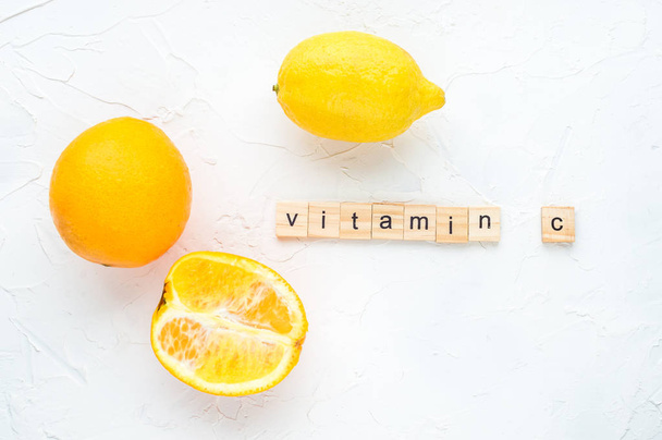 Concept vitamin c. Lemon and oranges on a white background - 写真・画像