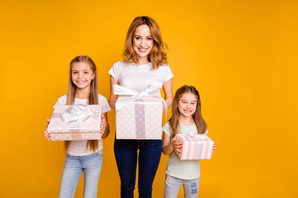 Portrait of three nice cute adorable lovely winsome attractive cheerful cheery positive blonde people holding in hands boxes day isolated over bright vivid shine yellow background - Fotografie, Obrázek