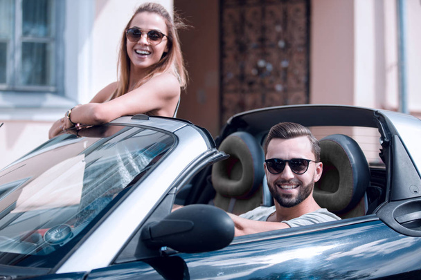 young couple in convertible car. - Φωτογραφία, εικόνα