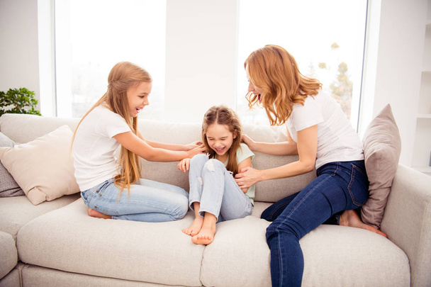 Portrait of nice cute lovely attractive adorable cheerful cheery positive funny ginger hair people mom mommy mum pre-teen girls playing on divan in house indoors - Valokuva, kuva