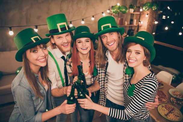 Close up photo company buddies hands raise beer bottles laugh laughter in bar pub celebrating funny funky carefree every year tradition st paddy day holiday weekend vacation free time leisure rejoice - Фото, изображение