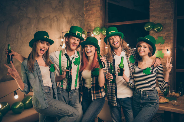 Best friends company in traditional national culture irish leprechaun costumes holding hands arms in v-sign drinking beer beverage laugh laughter funny funky best vacation weekend holiday - 写真・画像