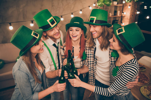 Clover leaf leprechaun hat costume tradition national culture beer in hands arms pub bar company in circle tell speak talk toasts bring bottles together great holiday weekend vacation concept - Photo, Image