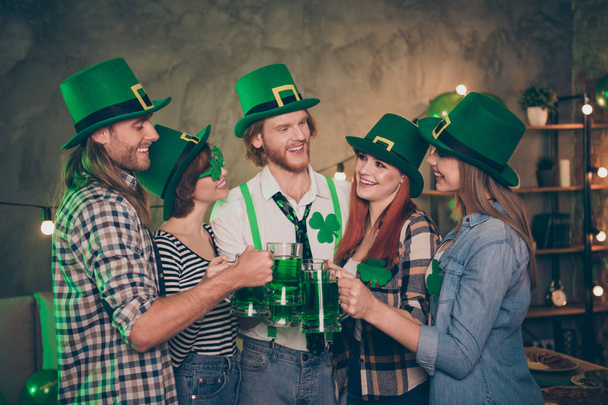 Group company cheerful five members green tradition culture national drink carefree lucky leaf style specs hats listening to toast decorated room place flat house casual shirt jeans clothes - Valokuva, kuva