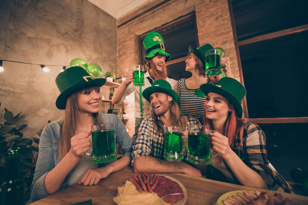 Group company hands arms raise alcohol wear national culture costumes tradition hats checkered plaid jeans shirts lucky false beard mustache laugh laughter toasting table full of tasty stuff - Fotoğraf, Görsel