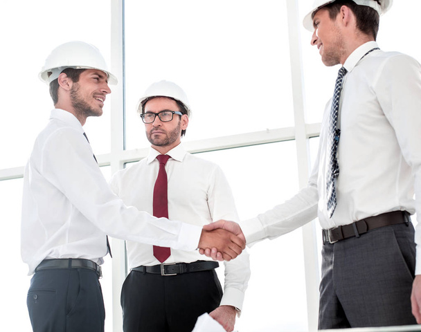 Two architects shaking hands after a meeting in office - Фото, изображение