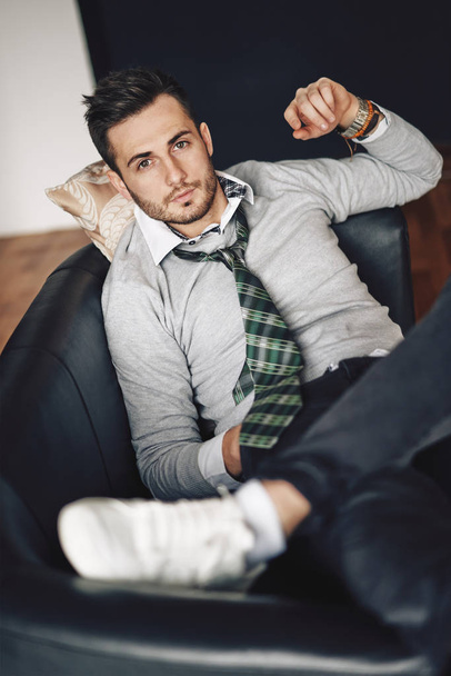 Handsome hipster man relaxing in sofa. rest and leisure concept - Фото, зображення