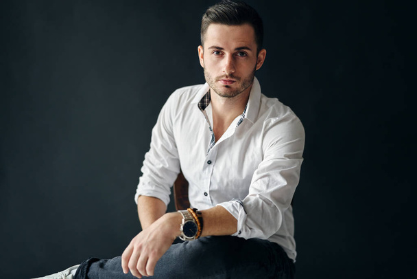 Stylish handsome man portrait on dark background. young and success concept              - 写真・画像