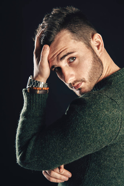 Portrait of handsome stylish man touching his hair posing on dark background                              - Fotografie, Obrázek