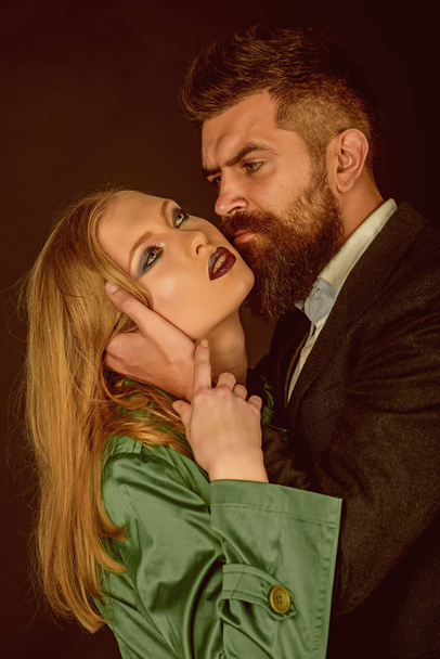 Seeing the best in your lover. Fashion style and hair care. Bearded man hug woman with long hair. Couple in love. Style icons. Intimate couple in fashion clothing. They both love fashion - Fotó, kép