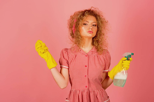 Housekeeper in rubber gloves with cloth and sprayer. Lady housekeeper ready to clean. Cleaning at its finest - Фото, изображение