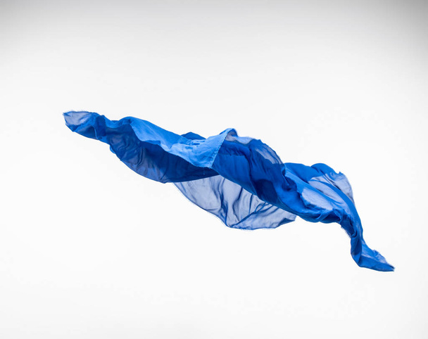 abstract piece of blue fabric flying, high-speed studio shot - Foto, Imagem