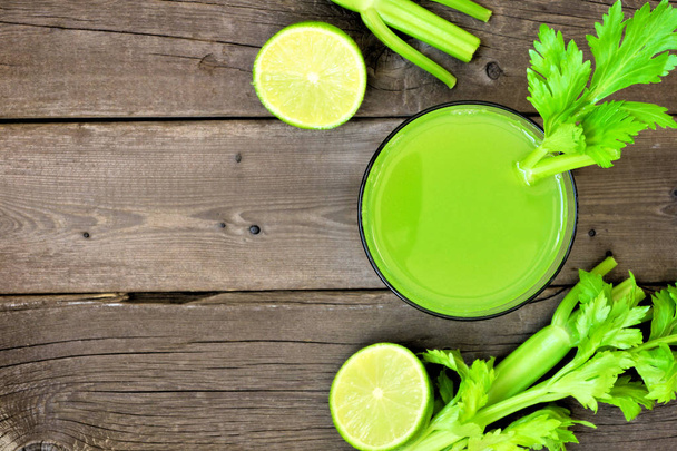 Healthy celery juice in a glass. Top view over a rustic wood background. Copy space. - Photo, Image