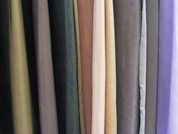 Selection of colorful fabrics for curtains, rolls of fabrics. Woolen, textiles. - Photo, Image