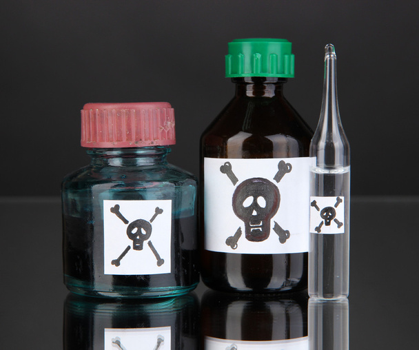 Deadly poison in bottles on black background - Photo, Image
