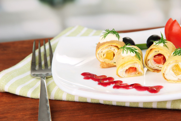 Egg rolls with cheese cream and paprika,on plate, on bright background - Photo, image
