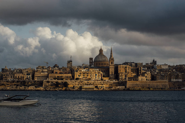 Beautiful view from Sliema to Valletta in the evening, Our Lady of Mount Carmel Basilica, Malta - Photo, Image