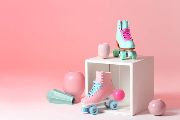 Composition with vintage roller skates and storage cube on color background. Space for text - Fotó, kép