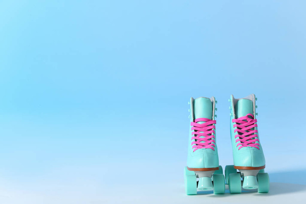 Pair of vintage roller skates on color background. Space for text - 写真・画像