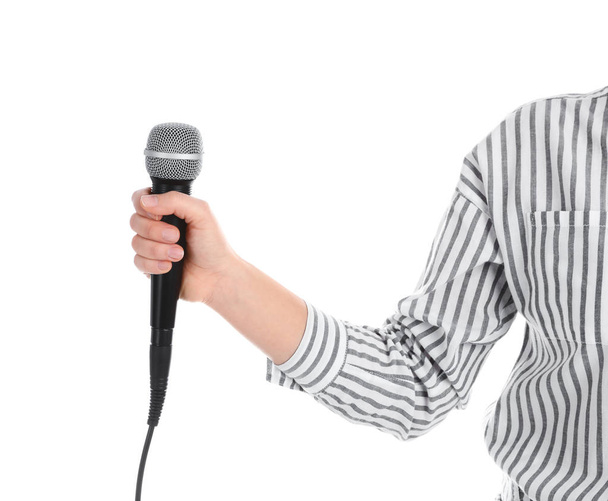 Young woman holding microphone on white background, closeup - 写真・画像
