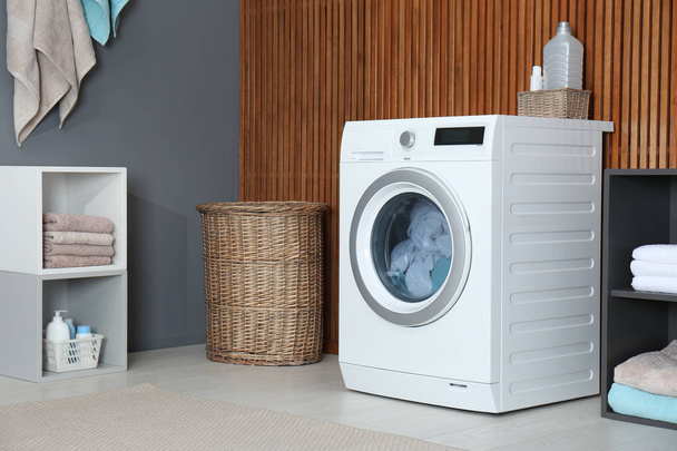 Washing of different towels in modern laundry room - Photo, image