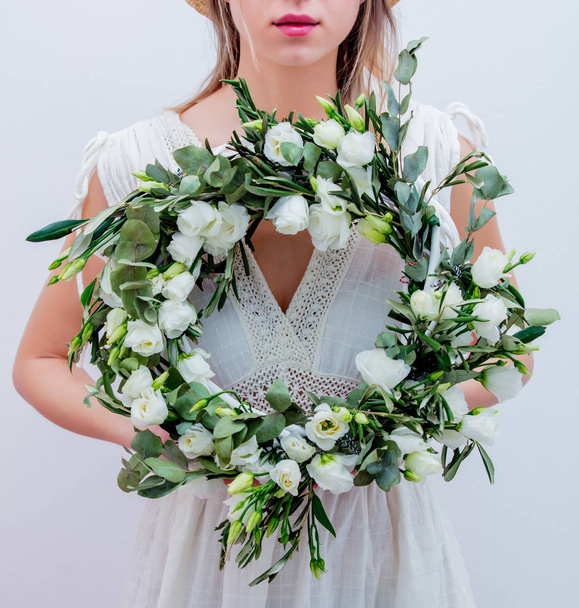 Beautiful woman with white roses wreath on white background - Photo, Image
