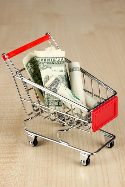 Money in cart on wooden table close-up - Fotoğraf, Görsel