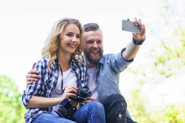 Young loving couple making selfie photo outdoor. Love, relations and date concept. - Foto, Imagen