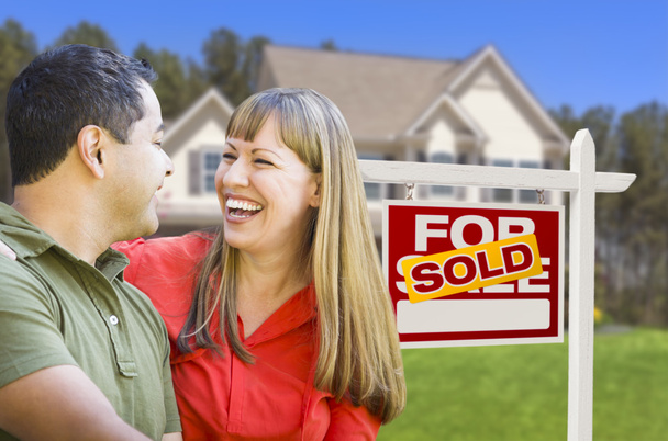 Couple in Front of Sold Real Estate Sign and House - Фото, зображення
