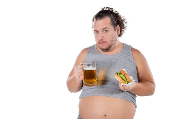 Funny fat man eating burger and drinking alcohol beverage - Fotografie, Obrázek