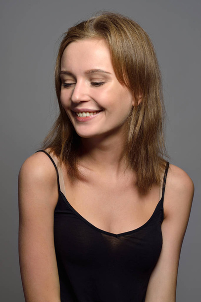 Emotional Torso Portrait of the beautiful woman  in black top. Happy smiling and natural make up. - Fotó, kép