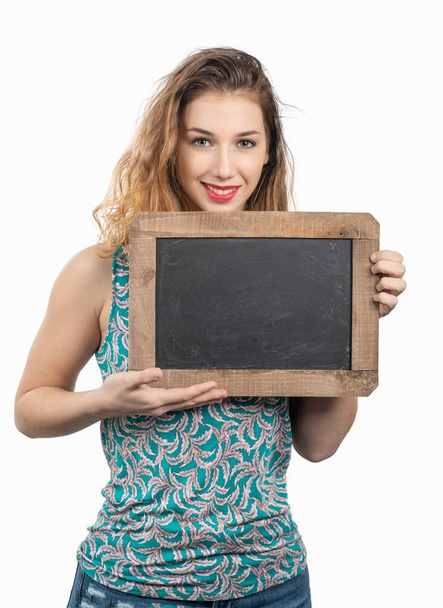 pretty young woman showing a small chalkboard on white background - Photo, Image