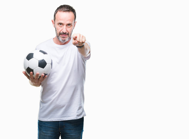 Middle age hoary senior man holding soccer football ball over isolated background pointing with finger to the camera and to you, hand sign, positive and confident gesture from the front - Foto, imagen