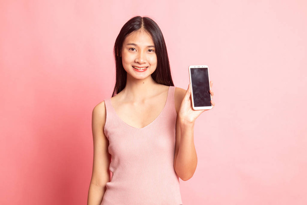 Young Asian woman with mobile phone on pink background - Fotoğraf, Görsel