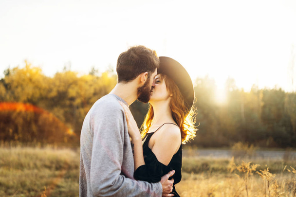 Pretty young romantic couple spend time together outdoor - Фото, изображение