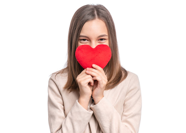 Happy Valentines Day. Cute young Teen Girl in Love with Red plush Heart in her hands. Smiling Child looking at camera, isolated on white background. - Foto, imagen