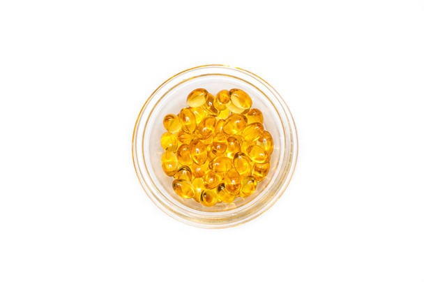 Plate of cod liver oil and fish oil , top view. The concept of health care and longevity. - Photo, image