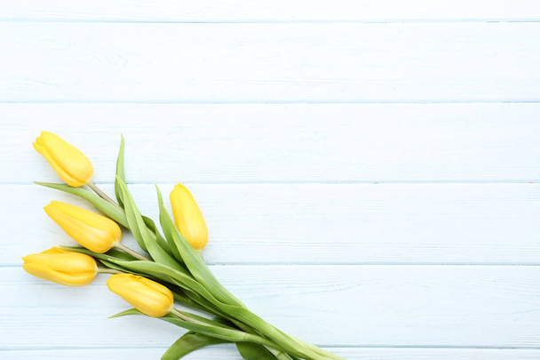 Bouquet of yellow tulips on wooden table - Фото, зображення