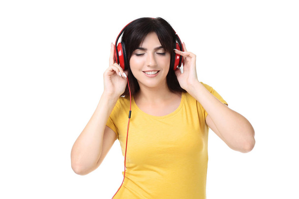Young woman with headphones on white background - Фото, изображение