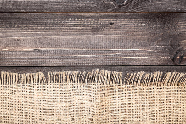 Sackcloth on brown wooden table - Fotó, kép