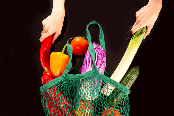 Family on shopping in super market concept. Bunch of vegetables & greens in reusable cotton net bag - Foto, Imagen